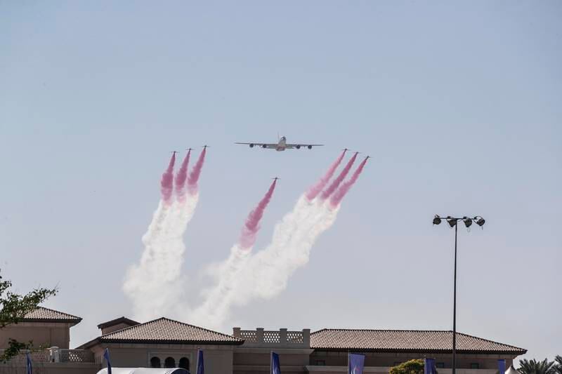 The Red Arrows and an Emirates A380 fly in formation over the DP World Tour Championship golf tournament at the Jumeirah Earth Golf Course