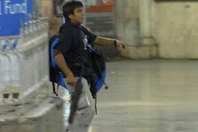 Mohammad Ajmal Kasab, the lone surviving gunman of the 2008 Mumbai attacks, walks on the premises of the Chhatrapati Shivaji Terminus or Victoria Terminus railway station in Mumbai, November 26, 2008.