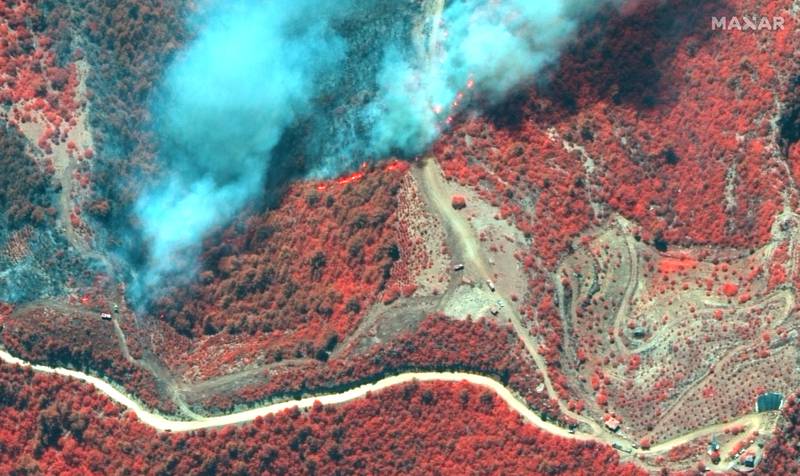 A colour infrared satellite image shows fire lines and crews battling a bushfire near Oymapinar, Turkey.