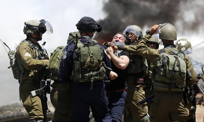 Palestinians face persecution daily, as can be seen here where Israeli soldiers detain a protester in the West Bank last month during a march in defence of Palestinian prisoners on hunger strike. Alaa Badarneh / EPA