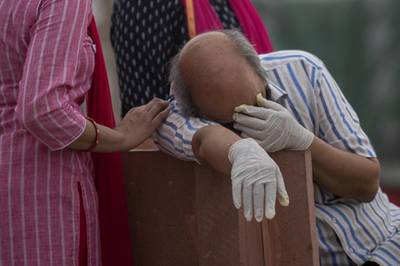 A distraught relative of a coronavirus victim at a cremation ground on the banks of the River Ganges at Garhmukteshwar in the northern state of Uttar Pradesh. Reuters
