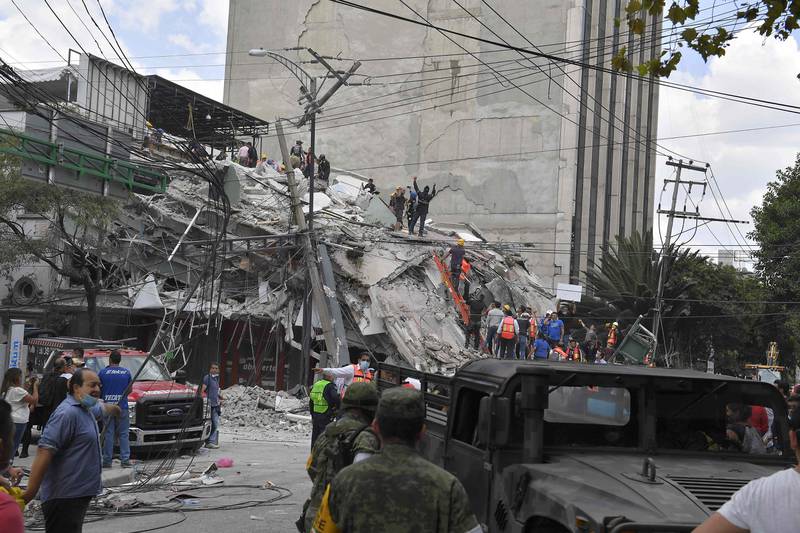 Rescuers work on the rubble from a building knocked down by a powerful quake in Mexico City. Omar Torres / AFP