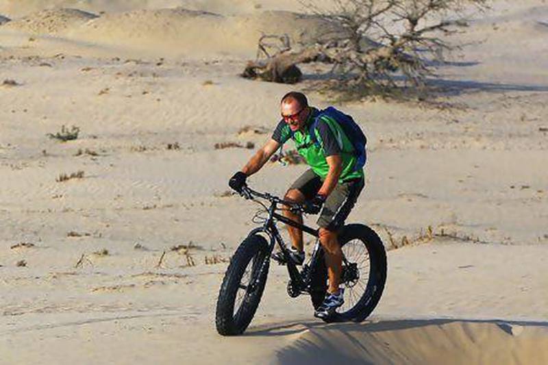 Ian Ganderton rides on the dunes outside Dubai. Setish Kumar / The National