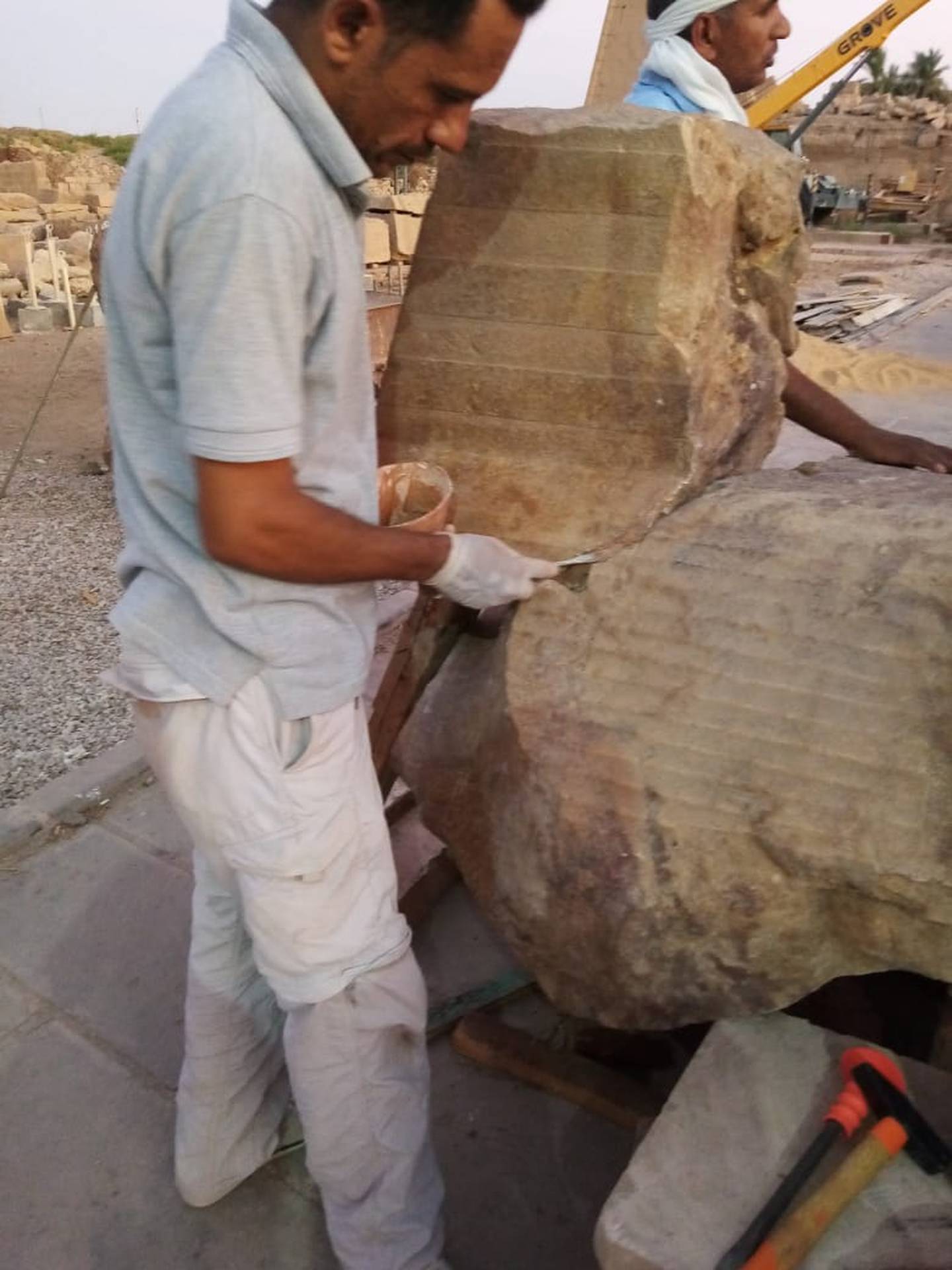 An Egyptian restorer working on the statue of Thutmose II in the famous Karnak temple in Luxor.  Photo: Egyptian Ministry of Tourism and Antiquities