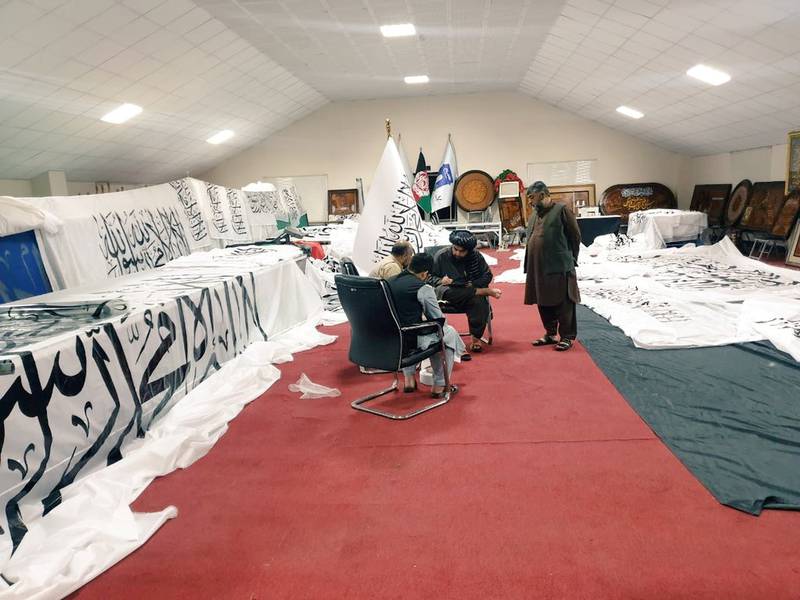 Unidentified people are surrounded by Taliban flags at an unidentified location, in this handout photo uploaded to social media. Reuters