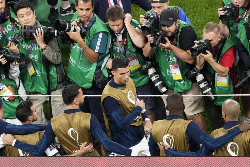 Phtographers surround Portugal subsitute Cristiano Ronaldo before the match. AP