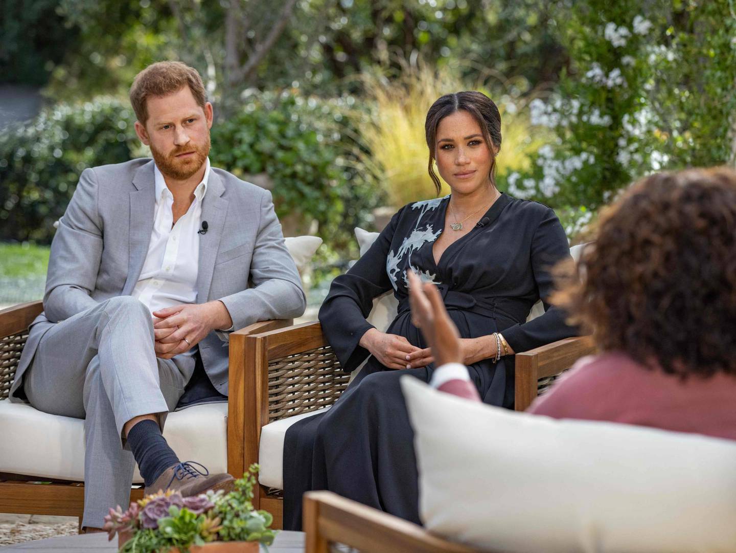 In this undated photo released by Harpo Productions on March 7, 2021, Britain's Prince Harry (L) and his wife Meghan, Duchess of Sussex (C) are shown in conversation with US TV host Oprah Winfrey.  Britain's royal family is bracing for further revelations from Prince Harry and his American wife Meghan on March 7, 2021, as a week of transatlantic claims and counterclaims culminates with the broadcast of an interview with Oprah Winfrey.  The two-hour interview with the US TV queen is the biggest royal news since Harry's mother, Princess Diana, revealed details of her 1995 marriage to his father, Prince Charles, which collapsed. 