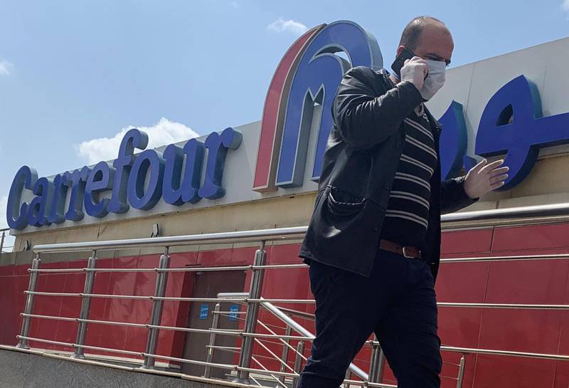 A man wearing a protective face mask walks outside a Carrefour hypermarket while Egypt ramps up its efforts to slow the spread the coronavirus disease (COVID-19) in Cairo, Egypt March 19, 2020. REUTERS/Amr Abdallah Dalsh