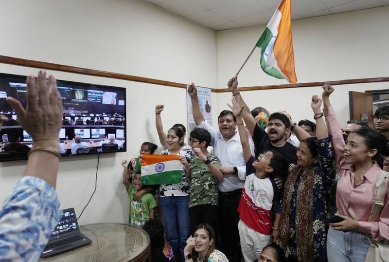 Indians celebrate the successful landing of Chandrayaan-3 at the Nehru Planetarium in New Delhi on Wednesday. AP