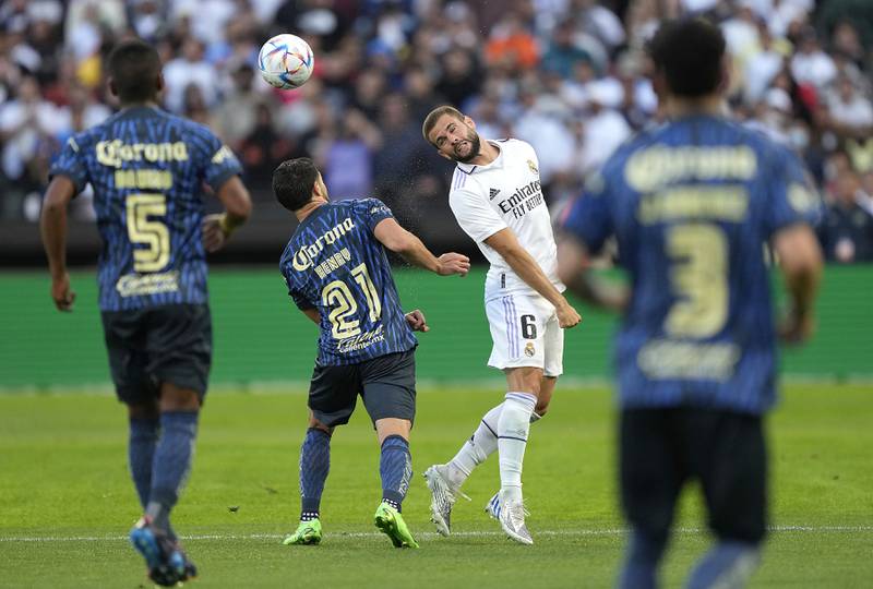 Real Madrid defender Nacho guides a header over the top of Henry Martin. Getty

