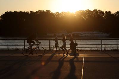Runners take advantage of cooler weather at sunrise to avoid the heat in Bordeaux, south-western France. AFP