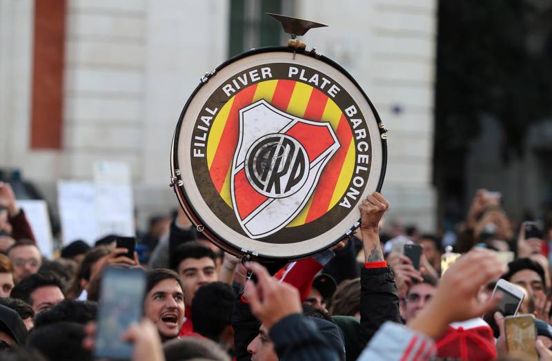 A drum is carried above the heads of cheering River Plate supporters during a gathering at the Puerta del Sol square. AP Photo