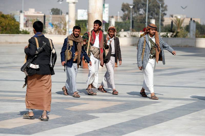 epa09001803 Armed Houthi supporters walk outside of a mosque in Sana'a, Yemen, 10 February 2021. The Houthi military spokesman Yehia Sareai has claimed his movementâ€™s responsibility for the bomb-laden drone- attack that targeted the Abha airport of Saudi Arabia, calling it a military objective.  EPA/YAHYA ARHAB