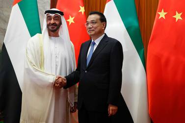 Sheikh Mohamed bin Zayed shakes hands with Chinese Premier Li Keqiang before a meeting at the Great Hall of the People in Beijing on Monday. Getty 