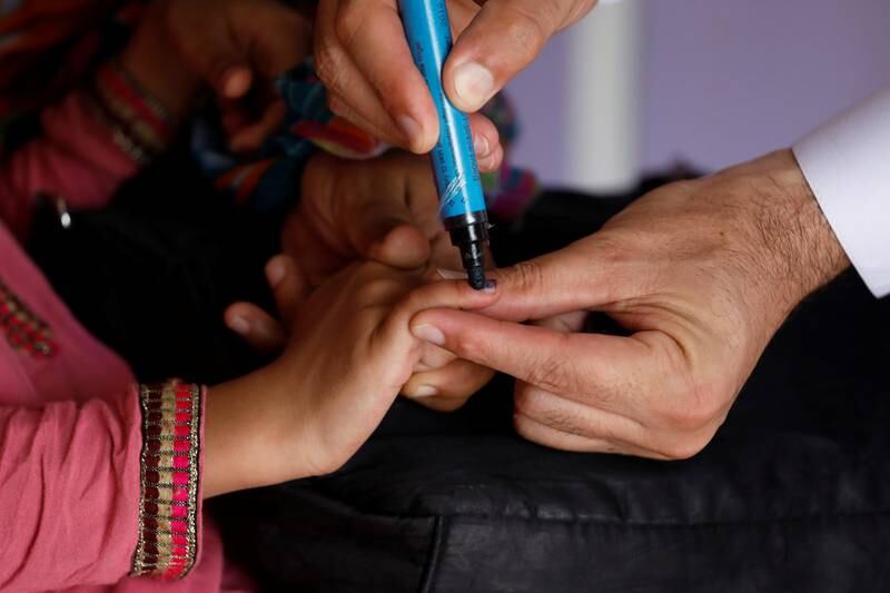 A girl gets her finger marked after she is administered polio vaccine drops at a civil dispensary in Peshawar. Reuters
