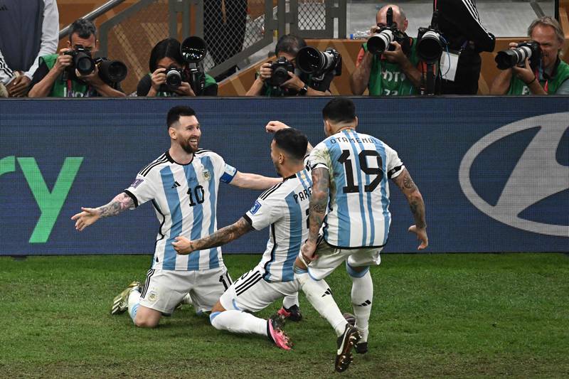 Lionel Messi celebrates with teammates after scoring Argentina's third. AFP
