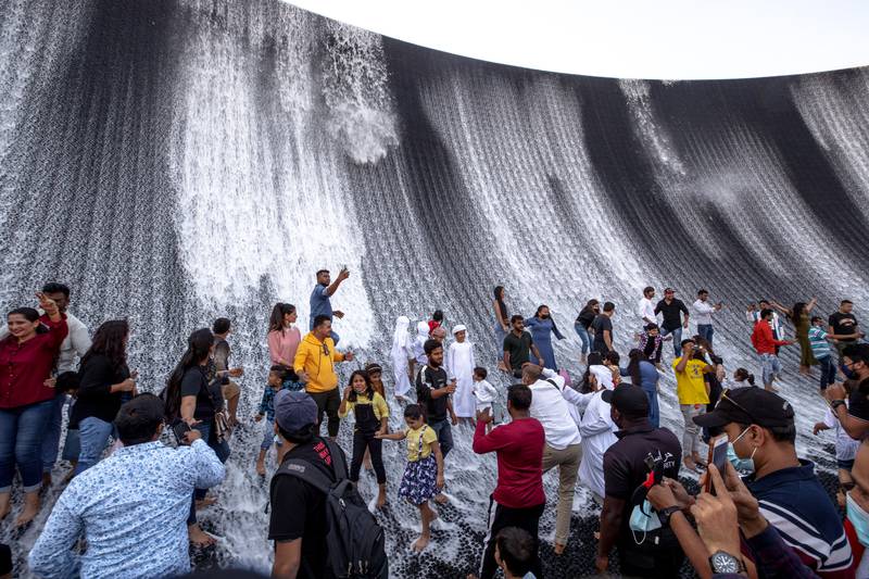 Visitors enjoy the Surreal water feature. Victor Besa / The National