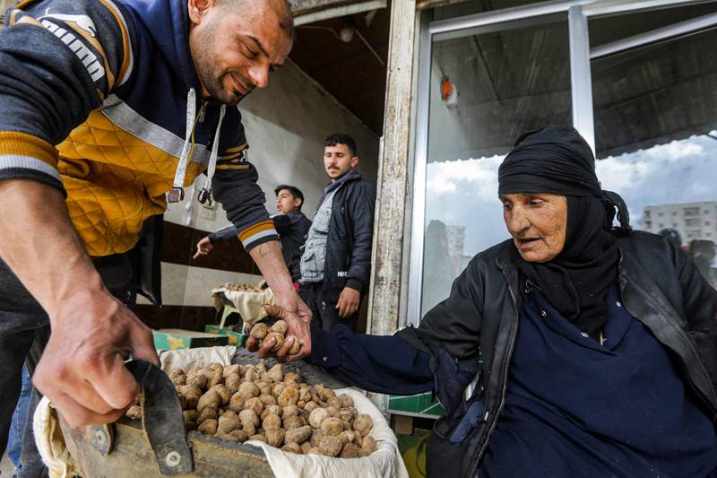 A merchant offers a customer desert truffles at a market in the city of Hama in west-central Syria. All photos by AFP