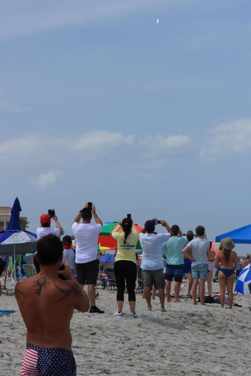 People view the launch from a beach in Florida. Reuters