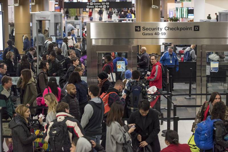 Travelers go through the security checkpoint at San Francisco International Airport (SFO) in San Francisco, California, U.S., on Thursday, Dec. 24, 2015. U.S. travelers over the year-end holiday season will surge to a record 100.5 million as cheap fuel makes trips more affordable. David Paul Morris / Bloomberg