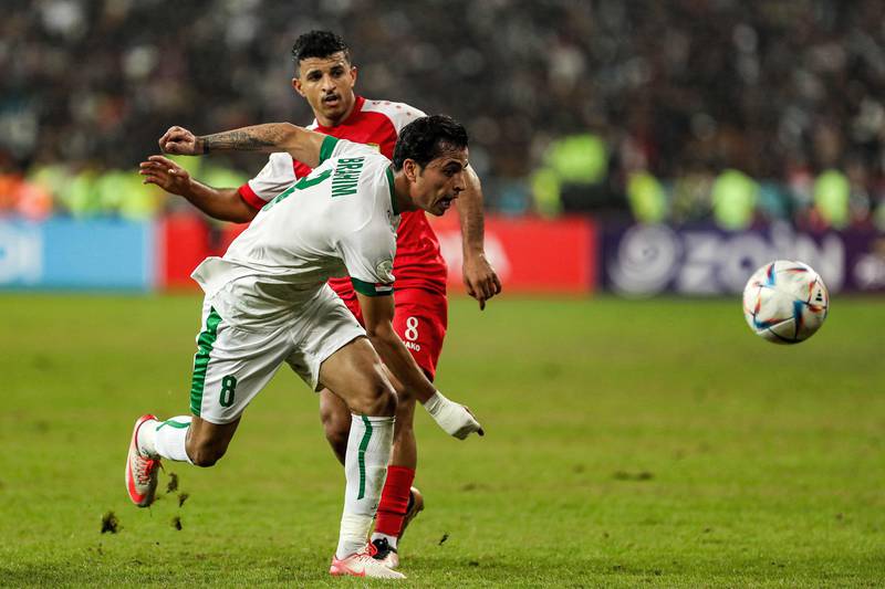 Bayesh vies for the ball against Oman forward Zahir Al Aghbari at Basra International Stadium in Iraq's southern city. AFP