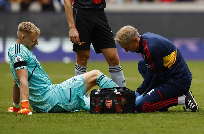 Arsenal's Aaron Ramsdale receives medical attention after sustaining an injury. Reuters