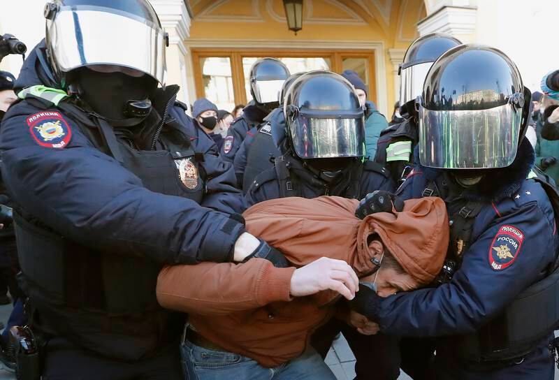Russian policemen detain a demonstrator in St Petersburg, during a protest against the country's military actions in Ukraine. EPA