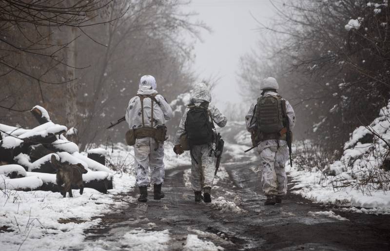 Ukrainian soldiers walk at the line of separation from pro-Russian rebels near Katerinivka, Donetsk region, Ukraine. AP