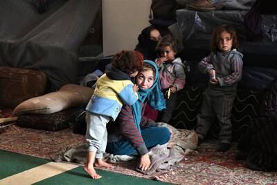 Syrian women play with their children after reaching the mosque. EPA