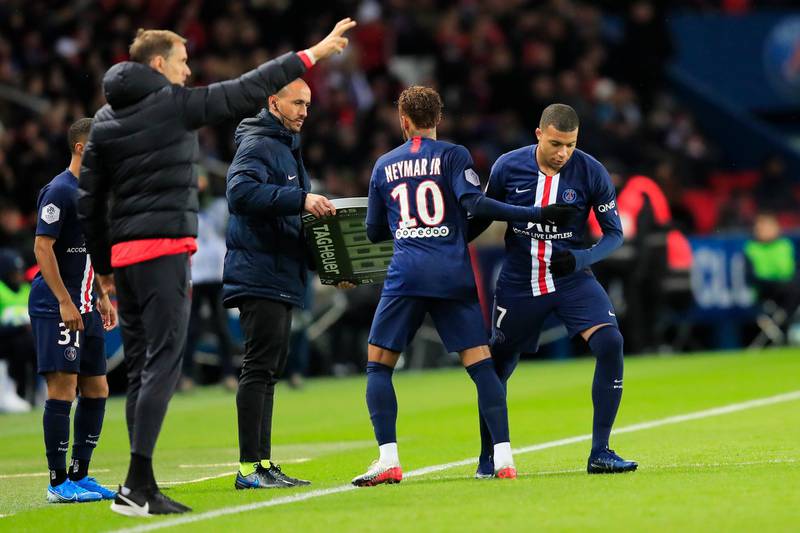 Neymar, second right, is replaced by teammate Kylian Mbappe as PSG head coach Thomas Tuchel gives instructions. AP