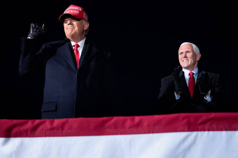 Mike Pence with Donald Trump at a Make America Great Again rally in Michigan in 2020. AFP