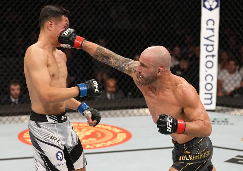 Alexander Volkanovski of Australia punches Chan Sung Jung during their UFC featherweight championship fight.