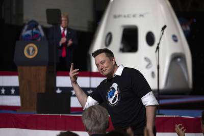 President Donald Trump acknowledges SpaceX founder Elon Musk,  right, after the successful launch of the SpaceX Falcon 9 rocket with the manned Crew Dragon spacecraft at the Kennedy Space Centre in Cape Canaveral, Florida. AFP