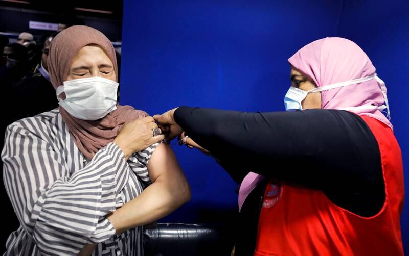 A woman in Cairo receives a Covid-19 vaccine in November. Reuters