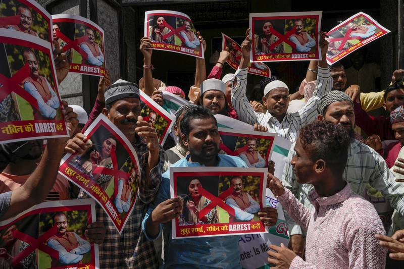 Muslims hold placards during a protest outside a mosque in Mumbai. AP 