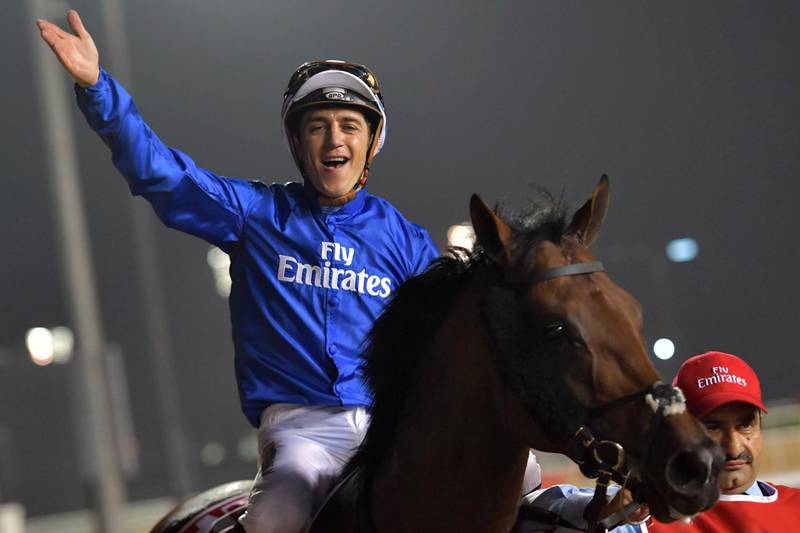 Jockey Christophe Soumillon gestures as he rides Thunder Snow after winning the Dubai World Cup horse race at the Dubai World Cup in the Meydan Racecourse on March 31, 2018 in Dubai. / AFP PHOTO / GIUSEPPE CACACE