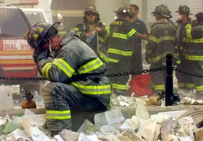 Firefighter Gerard McGibbon, of Engine 283 in Brownsville, Brooklyn, prays after the buildings collapse. Getty Images