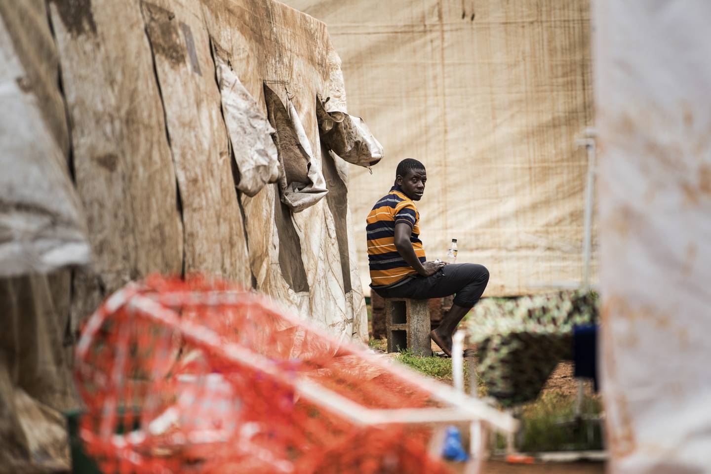 A cholera patient sits outside an isolation ward at the Bwaila Hospital in Lilongwe, central Malawi. AP