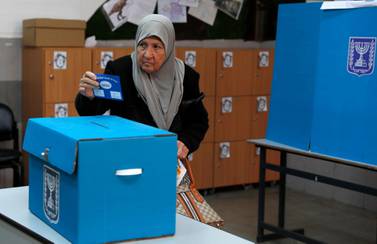 An Israeli Arab elderly citizen from Taiybe town casts her ballot at a polling station, during the Elections of the 21st Knesset of Israel. EPA