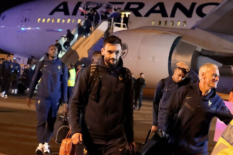 Hugo Lloris, Kylian Mbappe and Didier Deschamps arrive back in Paris. AFP