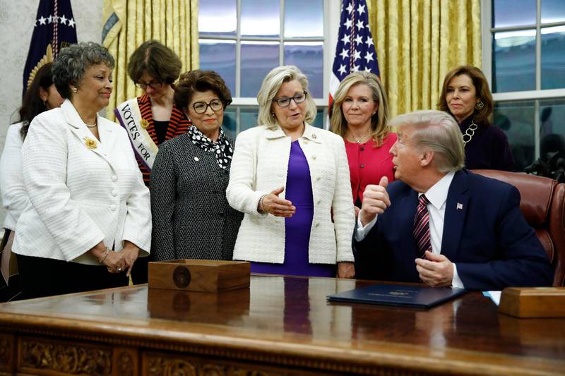 FILE - In this Nov. 25, 2019, file photo, Rep. Liz Cheney, R-Wyo., center, speaks with President Donald Trump during a bill signing ceremony for the Women's Suffrage Centennial Commemorative Coin Act in the Oval Office of the White House in Washington. Trump and his supporters are intensifying efforts to shame members of the party who are seen as disloyal to the former president and his false claims that last yearâ€™s election was stolen from him.(AP Photo/Patrick Semansky, File)