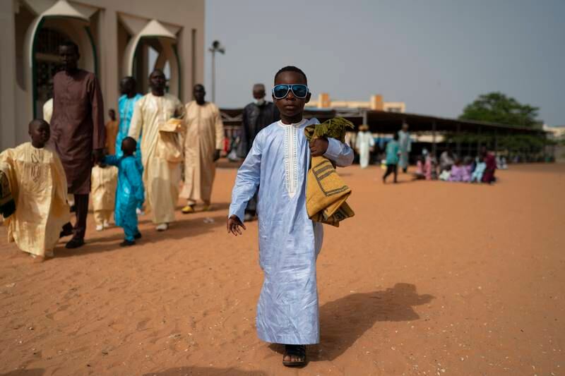 A boy walks away from mosque after Eid Al Adha prayers in Dakar, Senegal.