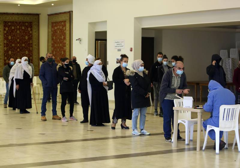 People wait in line to get tested for the coronavirus disease in the town of Hasbaya, Lebanon. Reuters