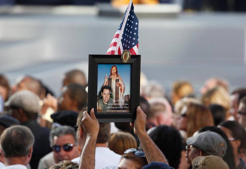 A person holds a picture remembering a victim of the attacks during ceremonies marking the 10th anniversary of the 9/11 attacks on the World Trade Center, in New York, September 11, 2011. REUTERS/Larry Downing (UNITED STATES - Tags: ANNIVERSARY DISASTER TPX IMAGES OF THE DAY) *** Local Caption ***  WTC625_SEPT11-_0911_11.JPG