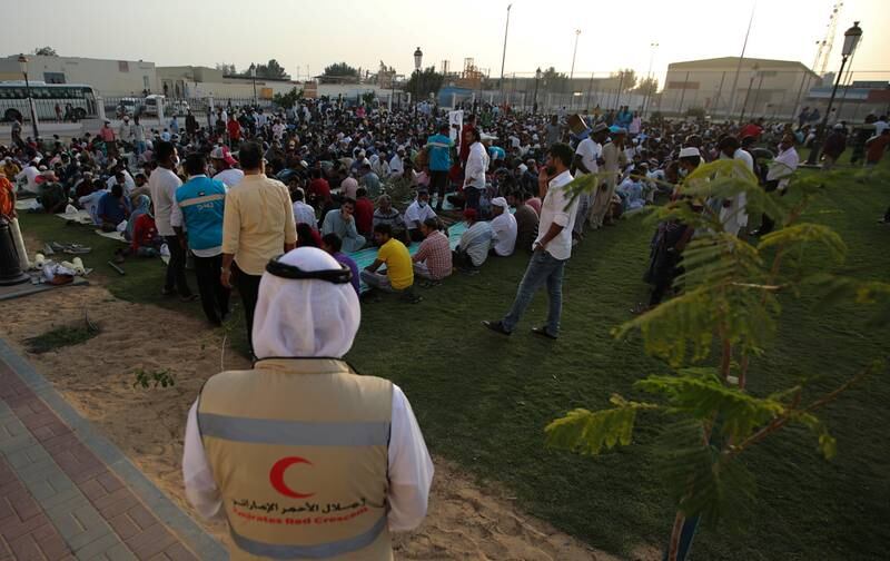 Muslim workers wait before breaking their fast at a mass iftar at Al Sajaa Labour Park in Sharjah in April 2022. EPA