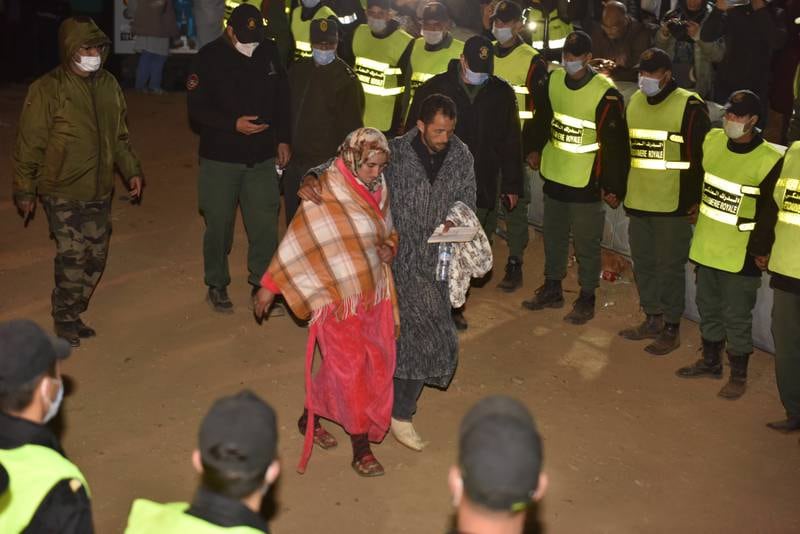 The parents of Rayan Aourram walk away after rescue workers retrieved his body from a deep well and placed it in an ambulance, in the village of Ighran in Morocco's Chefchaouen province. EPA