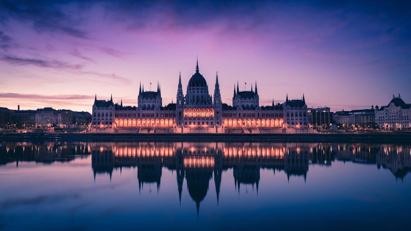 Illuminated Hungarian Parliament Building Against Sky At Dusk. Getty Images