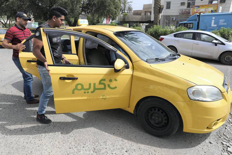 TO GO WITH AFP SPECIAL ABOUT KARIM TAXI (Photo by AHMAD AL-RUBAYE / AFP)