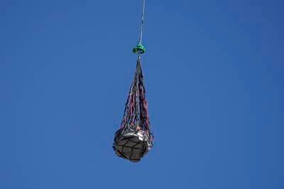 A helicopter transports the capsule. AP