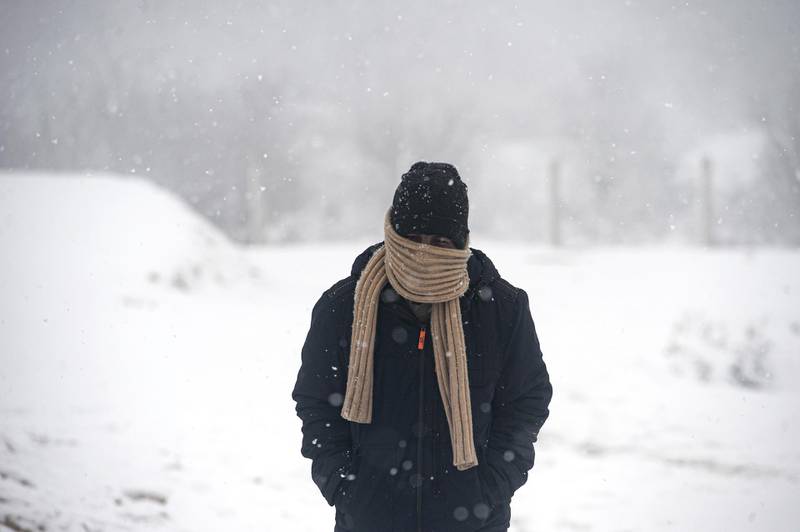 A migrant walks during snowfall at the Lipa camp. AP Photo